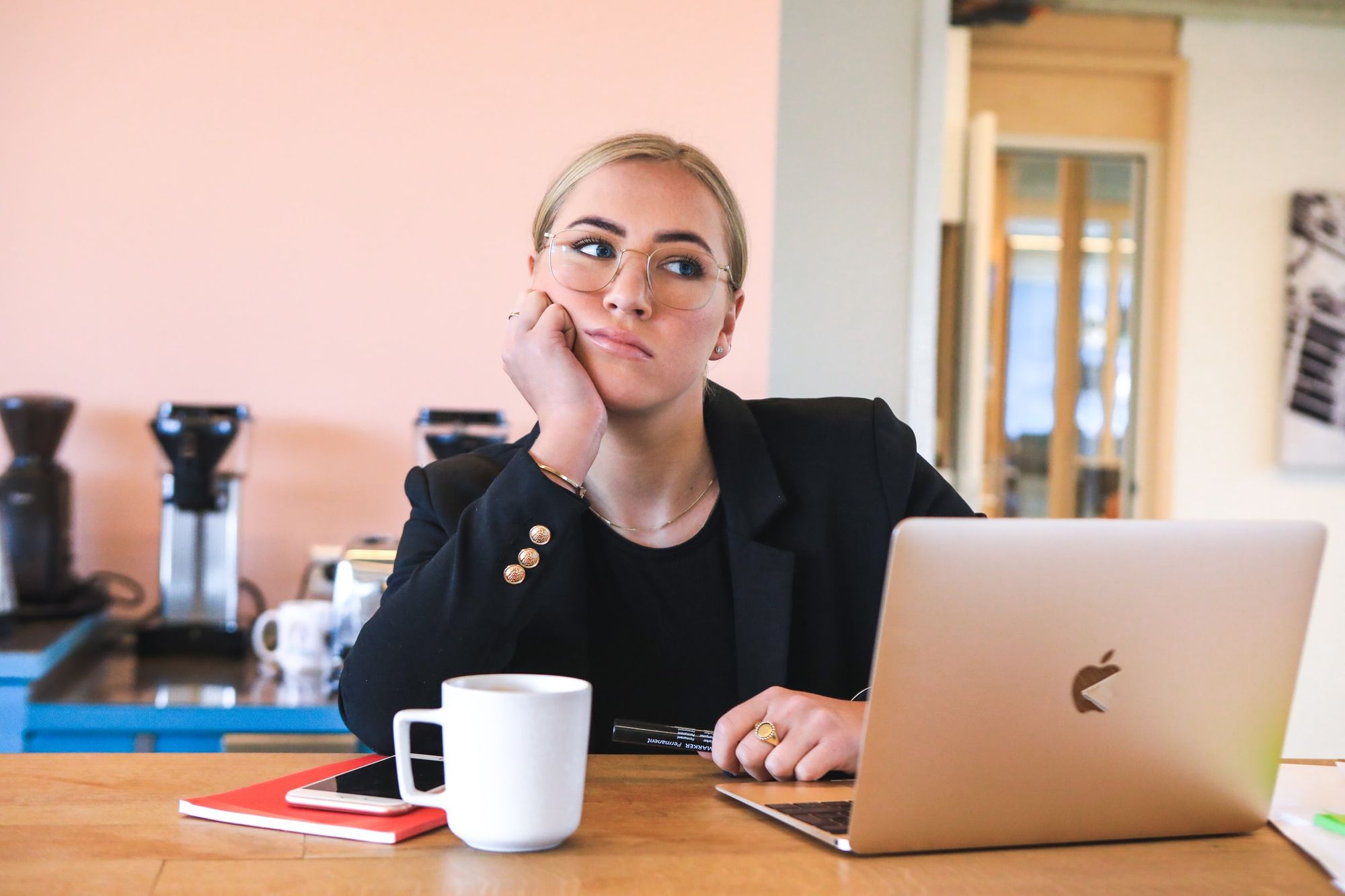 Woman sitting with a laptop and coffee at a table