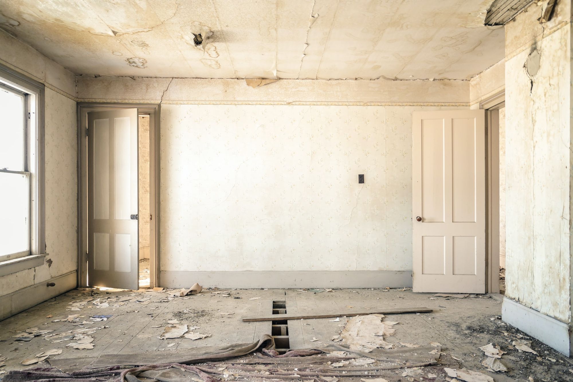 Empty room with exposed walls and flooring during a home renovation